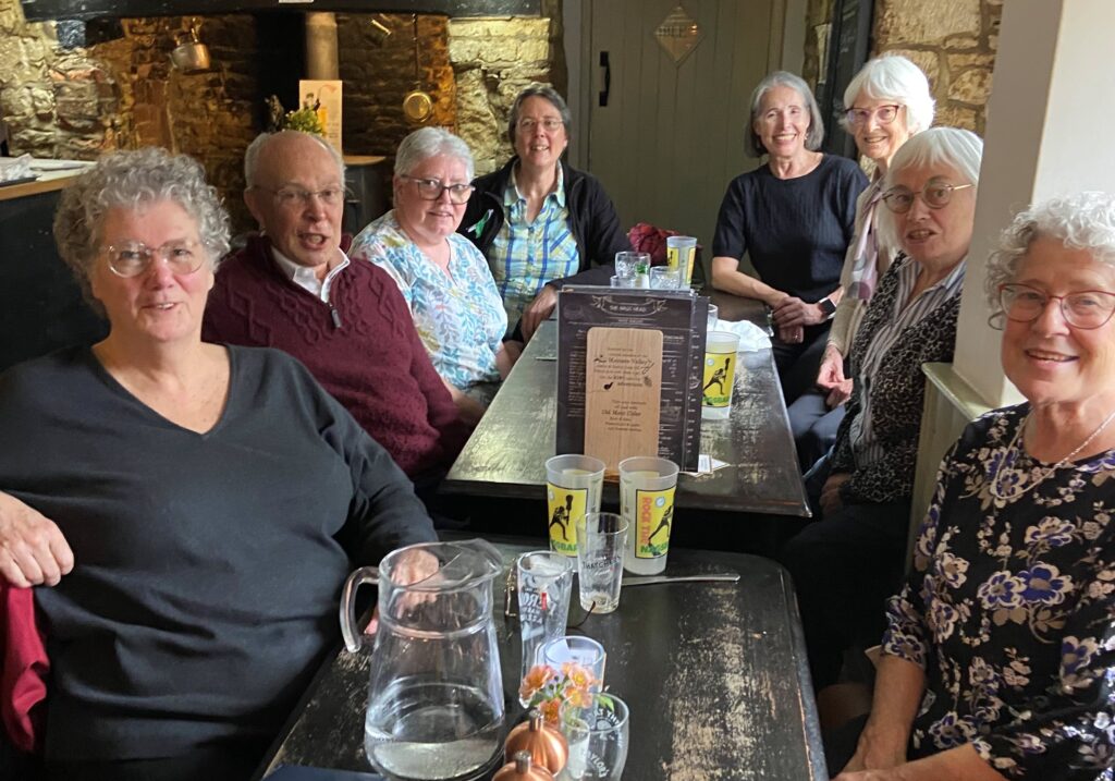 colour image of members sat around a table enjoying theiir pub lunch